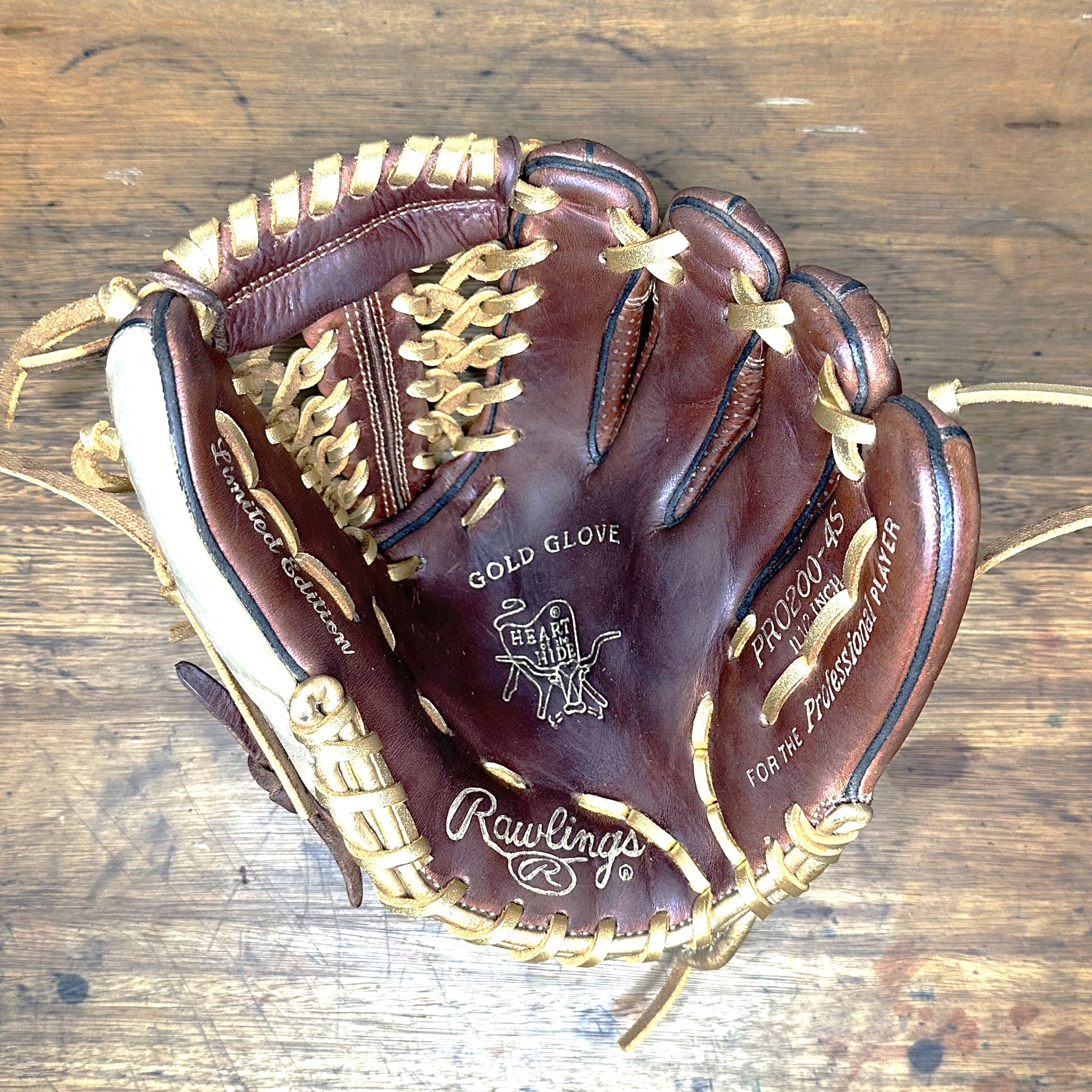 Rawlings Heart of the Hide PRO200-4S Sanotan 11.5 inch infield glove palm showing Gold Glove stamping and custom metallic gold laces on restored baseball glove
