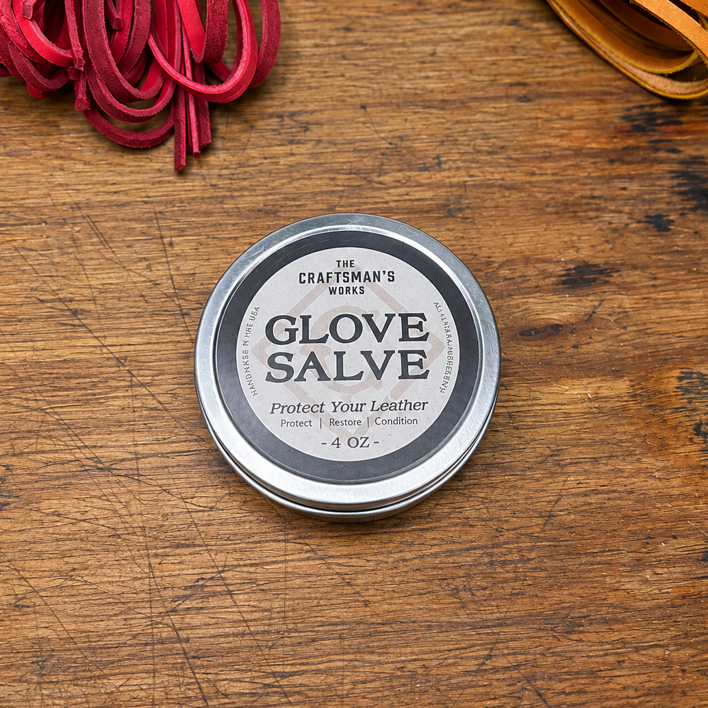 A tin of Glove Salve from The Craftsman's Works against a background of a rustic wooden bench.