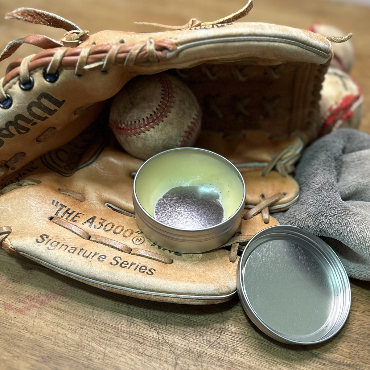 An open container of Glove Salve inside a Wilson "The A3000 glove"