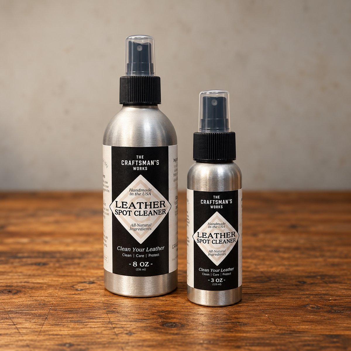 Leather Spot Cleaner bottles from The Craftsman's Works on a rustic wooden desk