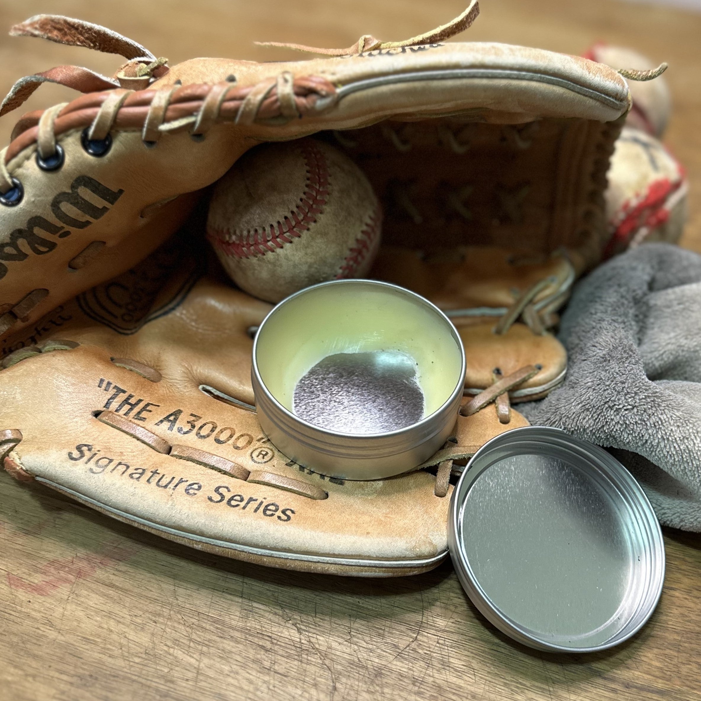An open container of Glove Salve inside a Wilson "The A3000 glove"